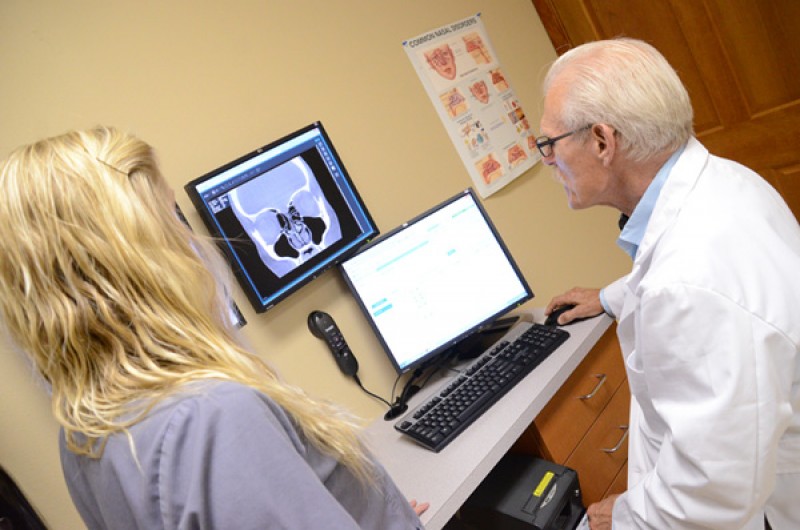 Dr. Setliff examining a CT scan with patient